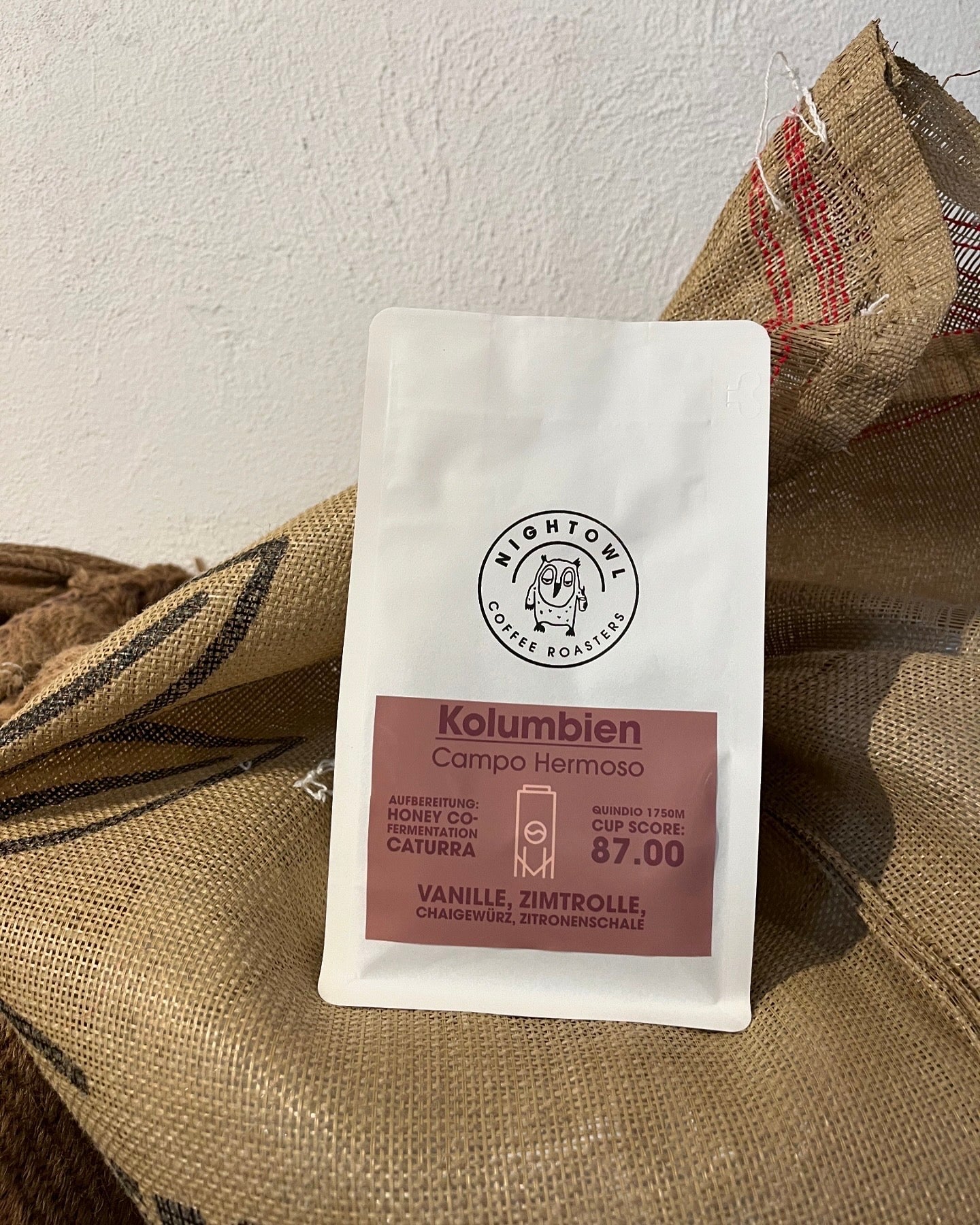 Weiße Kaffeverpackung mit Label in braun auf Kaffeesack.